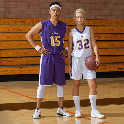 Custom A4 Youth's reversible shorts on basketball players in purple and white uniforms, showcasing moisture management technology.